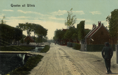 15334 Gezicht in de Herenweg (?) met wetering, bebouwing en beplanting te Wilnis uit het oosten.  N.B. De gemeente ...